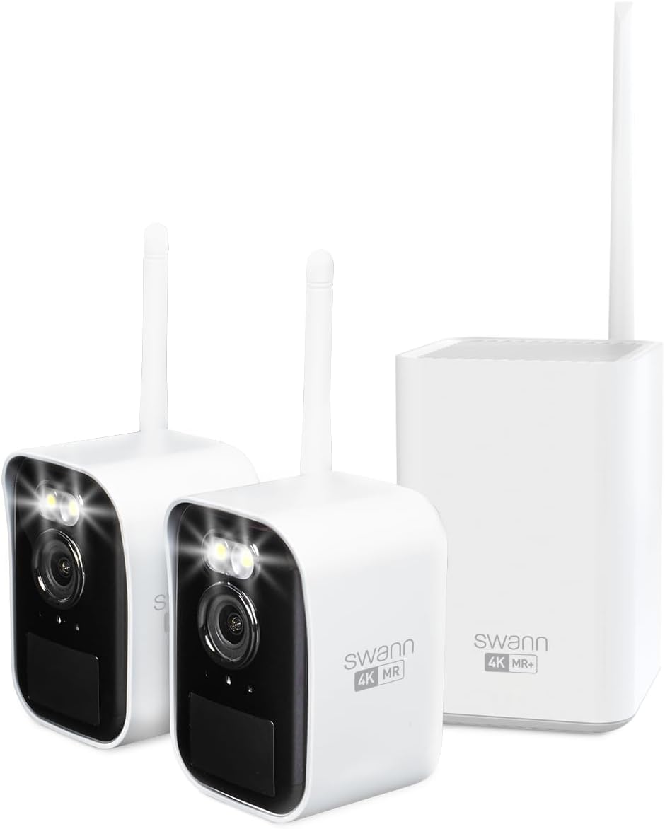 A Swann MaxRanger Mini camera mounted on an exterior wall at night, with its spotlights illuminated.