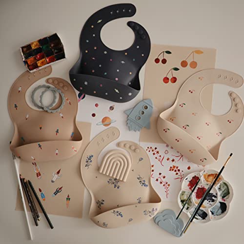 Image of mushie Silicone Baby Bib | Adjustable Fit Waterproof Bibs (Rocket Ship)