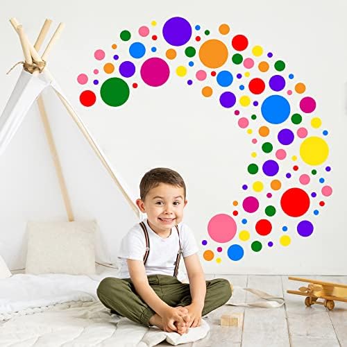 applied polka dot wall decals creating rainbow pattern in a nursery