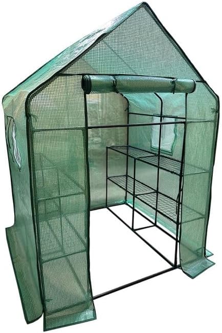 Interior view of the greenhouse with the cover installed, showing wire shelves and various potted plants.