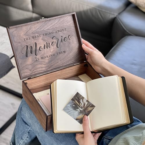 Wooden keepsake box beside an open photo album and printed family photographs.