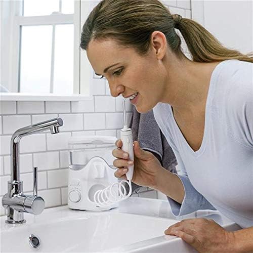 User operating Waterpik Ultra Plus Water Flosser