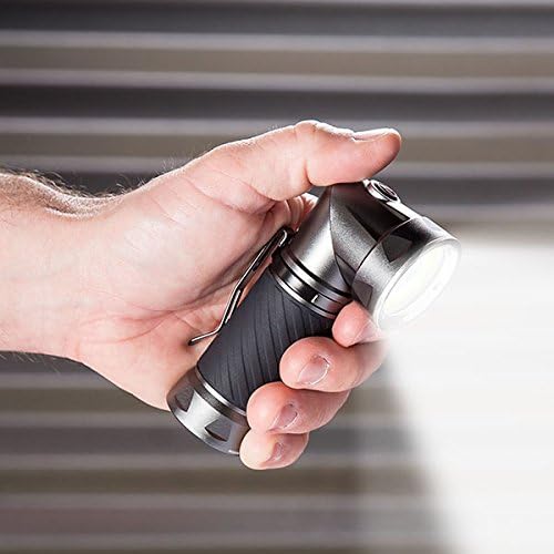 Hand holding Nebo CRYKET LED Flashlight with its head swiveled 90 degrees, illuminating a work area.