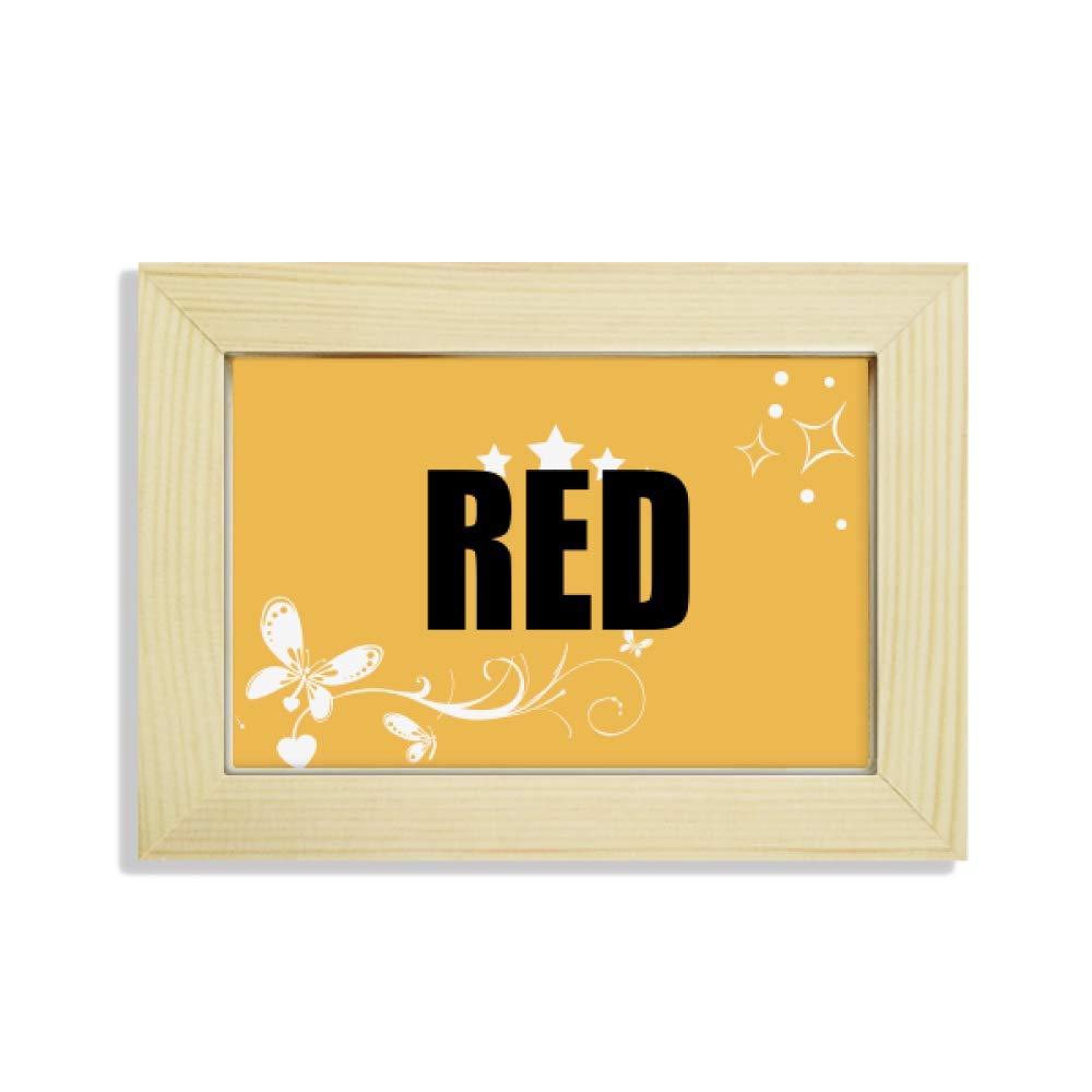 Escritorio de madera decorado con marco de fotos de flores y pintura de tonos rojos