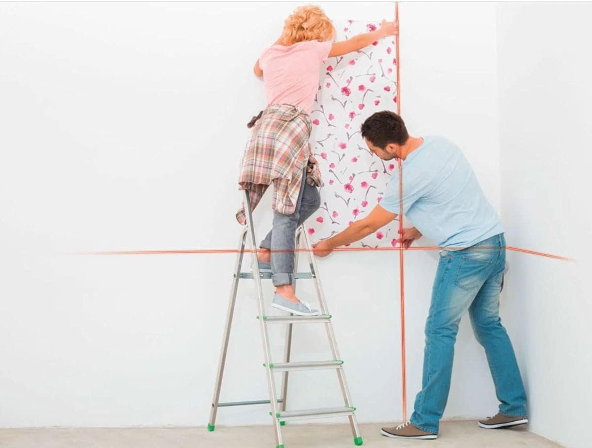 People using the laser level for wallpapering