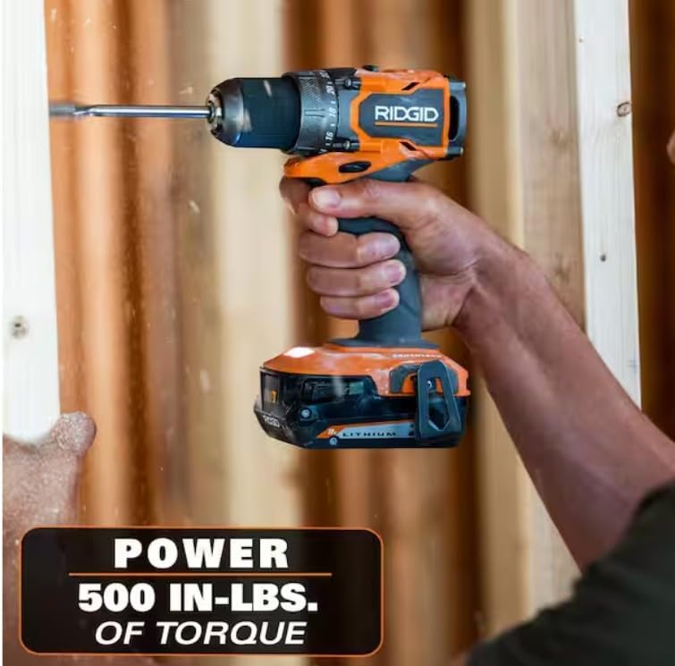 Person using the RIDGID R87012 drill/driver to drive a screw into a wooden board, showcasing its power and torque.