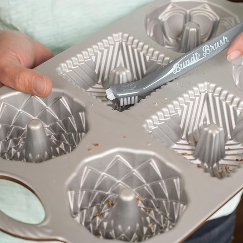 Image of Nordic Ware Platinum 12-Cup Bundt Pan - Cleaning Tool & Pot Holder Set | 75th anniversary edition | Recipe card included | 3-in-1 cleaning brush | Silver non-stick finish | Heat resistant grip