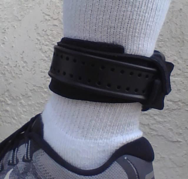 Side view of The Ankle Monitor Keep strap securely holding a GPS ankle monitor in place on a leg.