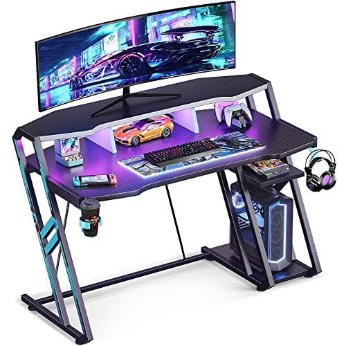 MOTPK Gaming Desk with LED Lights 47 Inch, Computer Desk with Monitor Storage Shelf, Gaming Table with Carbon Fiber Surface, Gamer Desk with Cup Holder & Headphone Hook, Gift for Boys Men, Black MOTPK Gaming Desk with LED Lights 47 Inch, Computer Desk with Monitor Storage Shelf, Gaming Table with Carbon Fiber Surface, Gamer Desk with Cup Holder & Headphone Hook, Gift for Boys Men, Black