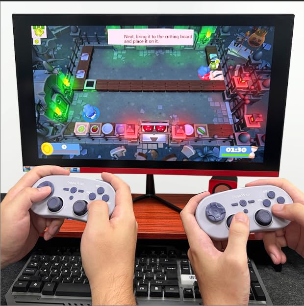 Two users holding ShanWan Q38 controllers, playing a game on a monitor connected to a PC.