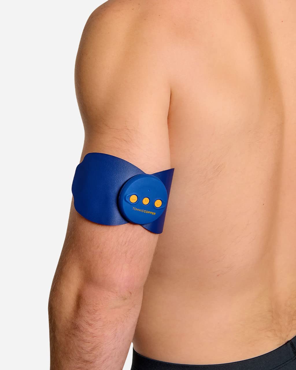 Tommie Copper TENS device applied to a man's arm.