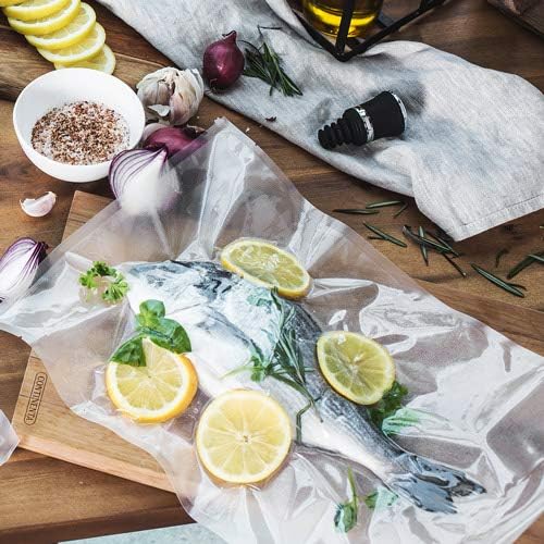 A whole fish with lemon slices and herbs, vacuum-sealed on a wooden board.