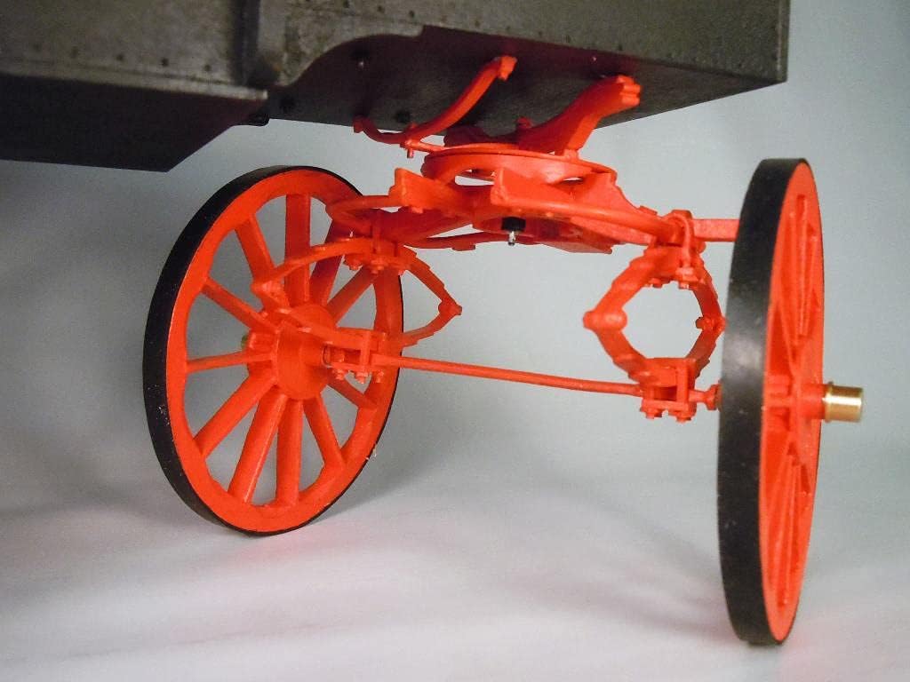 Undercarriage detail of the Model Expo MS6010 jail wagon model, showing the steering mechanism and suspension components.