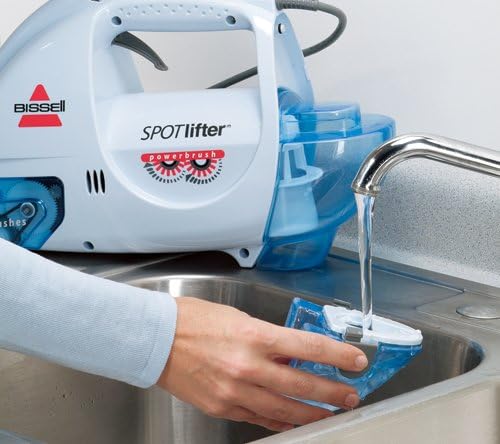 A person filling the clean water tank of the Bissell Spotlifter from a faucet.