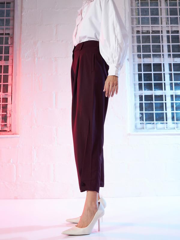 Image of SASSAFRAS Burgundy Button Hem Darted Balloon Pants