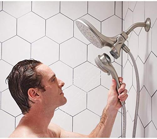 Man demonstrating the detachable handheld showerhead of the Moen Engage system
