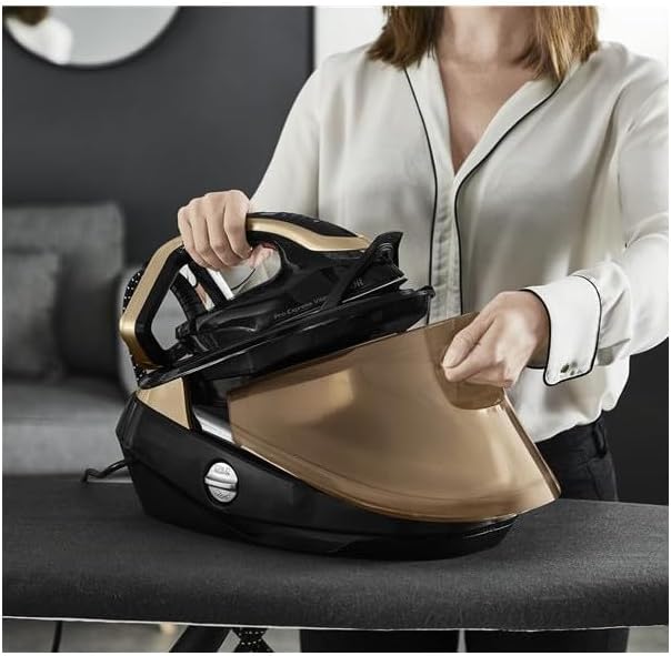 User placing the Calor GV9820C0 iron back onto its base, revealing the water tank