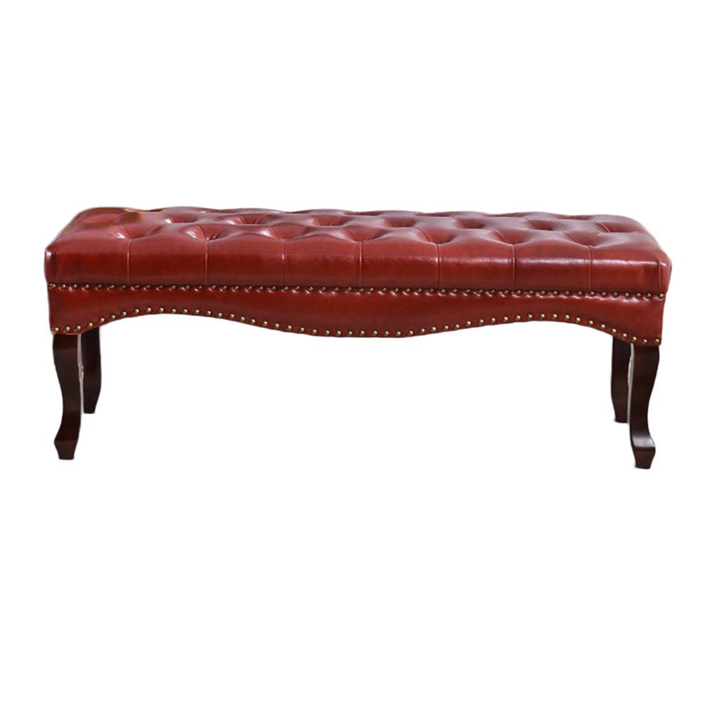 Banc de lit en cuir rouge pour changer de chaussures dans l'entrée
