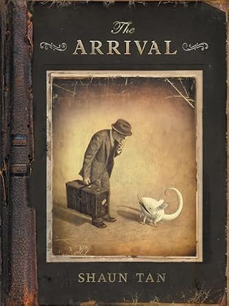 The Arrival by Shaun Tan, a graphic novel book cover depicting a person looking down at an abstract illustration of a white rat in a cracked, antique picture frame.