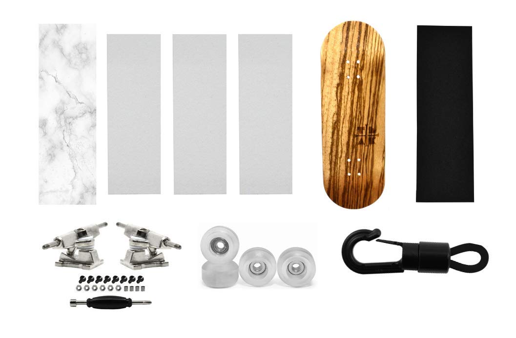 Teak Tuning Fingerboard Starter Set No. 4 - Includes Zebrawood Fingerboard Deck, 1 Deck Graphic Wrap, 3 Pieces of Skate Grip, 1 Piece of Trick Tape, Set of Silver Trucks, Clear Wheels, and a Carrier