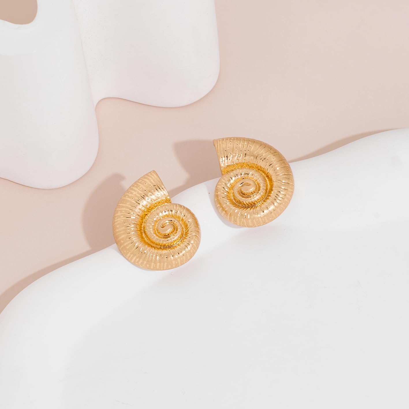 Worn Gold Conch Earrings And Starfish Earrings