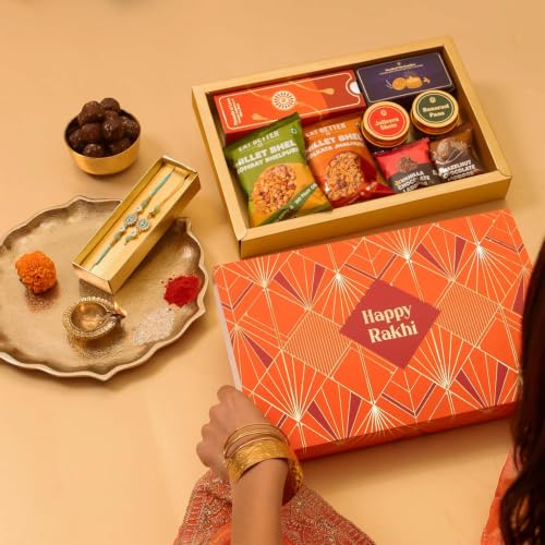 Image of Sneh 12-Item Rakhi Gift Hamper for Brother and Bhabhi - Bhaiya Bhabhi Rakhi Set, Evil Eye & Lumba Rakhi Combo, Roli-Chawal, Chocolate Dry-Fruit Laddoos, Millet Bhel, Candles, Mukhwas by Eat Better Co