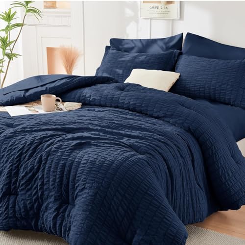 Image of HYMOKEGE Navy Blue Oversized King Comforter Set Seersucker 7 Pieces, All Season Luxury Bed in a Bag for Bedroom, Bedding Set with Comforter, Sheets, Pillowcases & Shams
