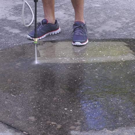 Demonstration of cleaning concrete surfaces with the pressure washer.