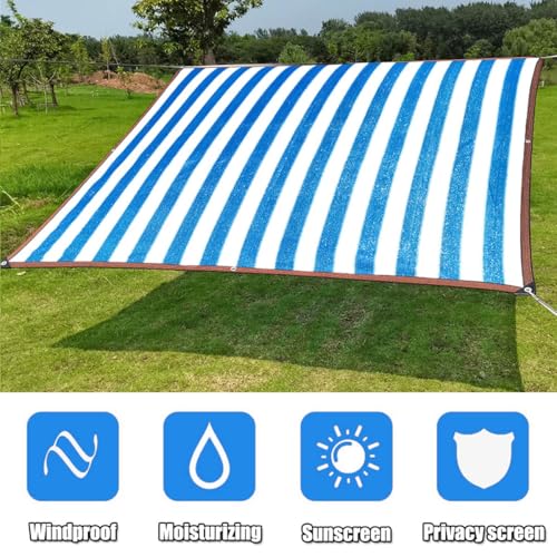 Toldo con ojales y tela azul y blanca que soluciona la falta de sombra en el jardín 6