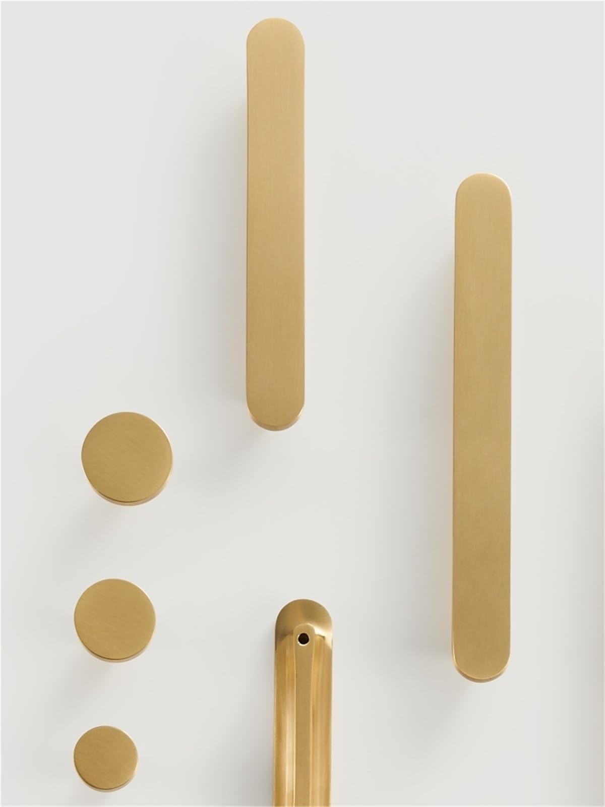 Poignées circulaires en laiton au design épuré pour une cuisine lumineuse