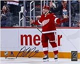 Alex DeBrincat Detroit Wings Autographed 8' x 10' Jersey Celebrating Photograph - Autographed NHL Photos