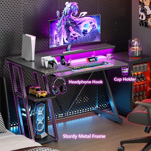 Image of Korfile 40 Inch Gaming Desk with Power Outlet & LED Lights, L Shaped Computer Gaming Table with 3 Tiers Storage Shelves, Corner Gamer Desk with Monitor Stand for Small Space, Carbon Fiber Black