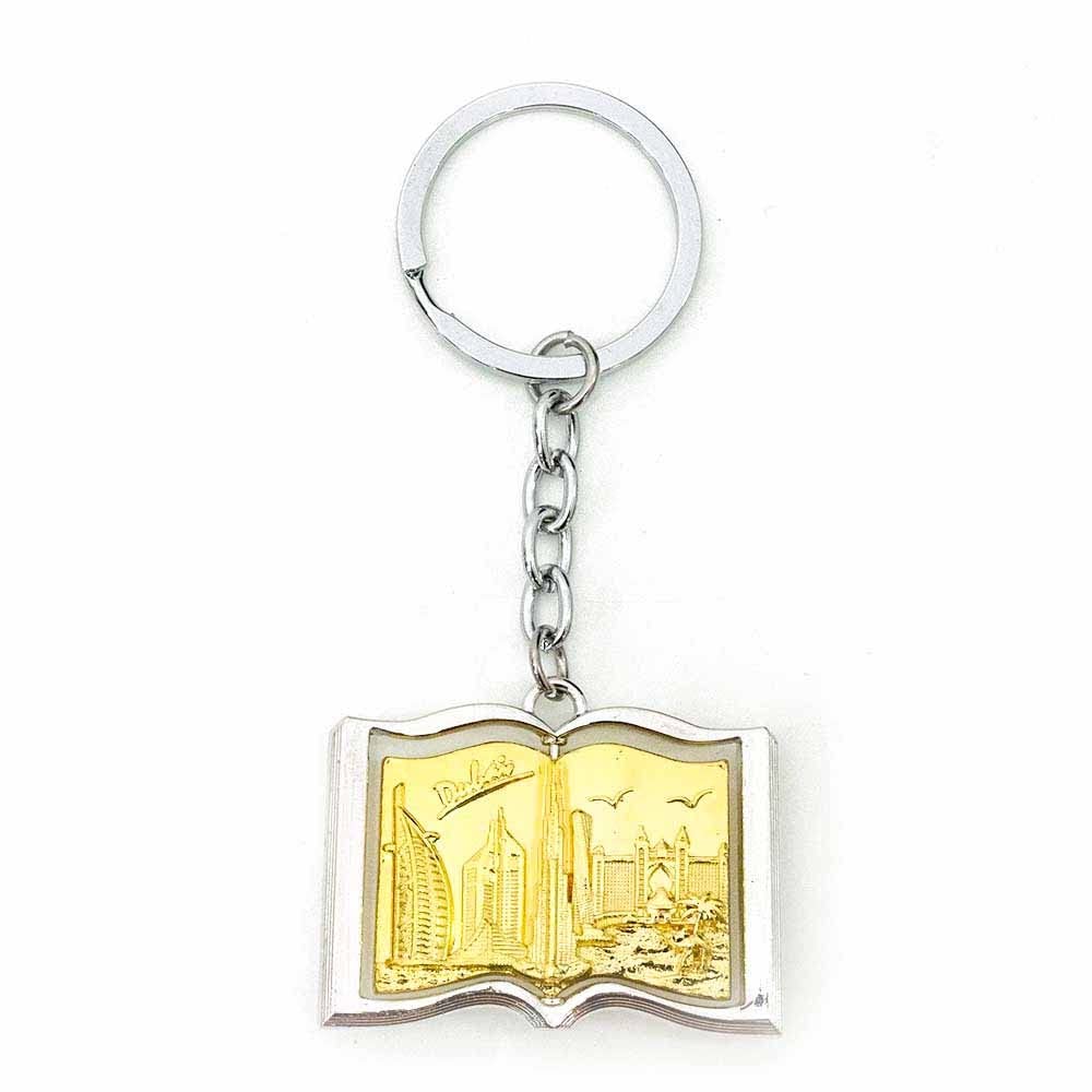 Silver Keychain with Golden Book Dubai Souvenir Design