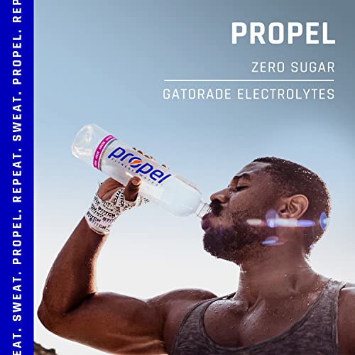 A shirtless man with dark hair and tattoos on his arms is drinking a bottle of Propel Zero Sugar in front of a blue sky background. The bottle has a black label with the word 'Propel' in white letters. The man is sweating and has a determined look on his face.