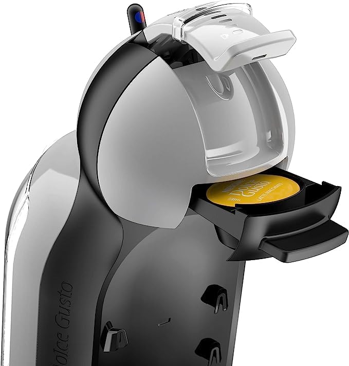 Close-up of a Nescafé Dolce Gusto capsule being inserted into the machine