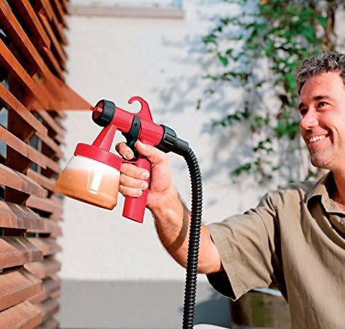Man spraying a wooden fence with CEVIK paint turbine