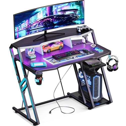 MOTPK Gaming Desk with Power Outlet & LED Lights, Computer Desk 40 Inch with PC Storage Shelf, Gaming Table with Carbon Fiber Texture, Gamer Desk, Gift for Boys Men, Black