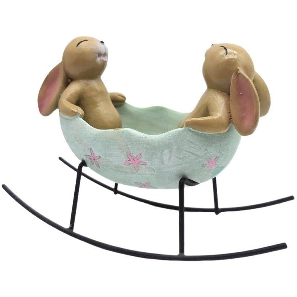Lapins à bascule dans un œuf de Pâques pour centre de table champêtre