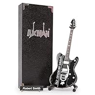 CRAFTED WITH PRECISION: This 10in/25cm wooden Miniature guitar with plastic and metal details includes a display stand, making it perfect for showcasing. Each order contains a handmade mini guitar, stand, display box, and artist name plate with 2 acr...