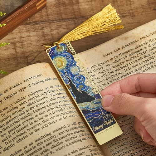 Decorative metal bookmark lying flat between book pages as an inexpensive polished gift