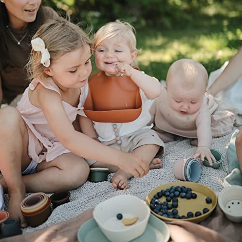 Image of mushie Silicone Baby Bib | Adjustable Fit Waterproof Bibs (Rainbows)