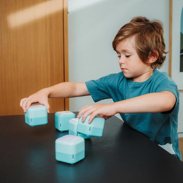 Child playing with multiple Tokidos PlayCubes on a table