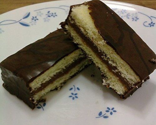 Two halves of a Haitai Oh Yes! cake, showing the chocolate coating, cake layers, and creamy filling.
