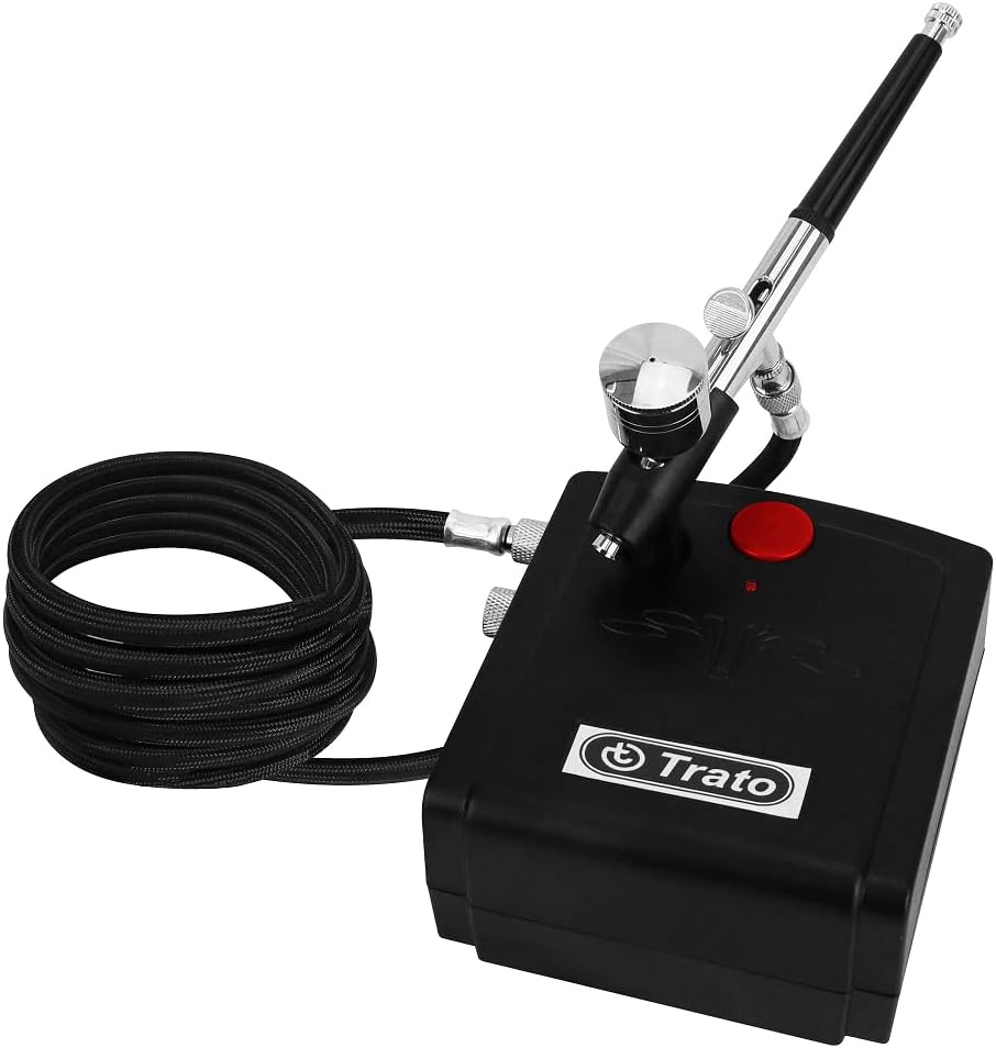 The Trato TKA12 Airbrush Kit showing the black mini compressor with a red power button, connected to a silver dual-action airbrush via a black braided hose.