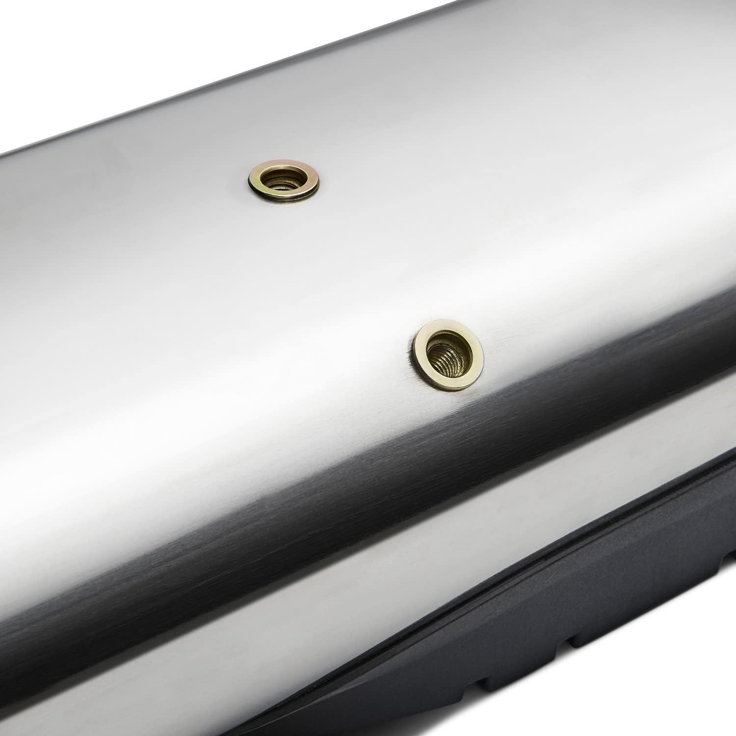 Close-up of two circular mounting holes on the underside of a polished stainless steel side step, with brass-colored inserts.