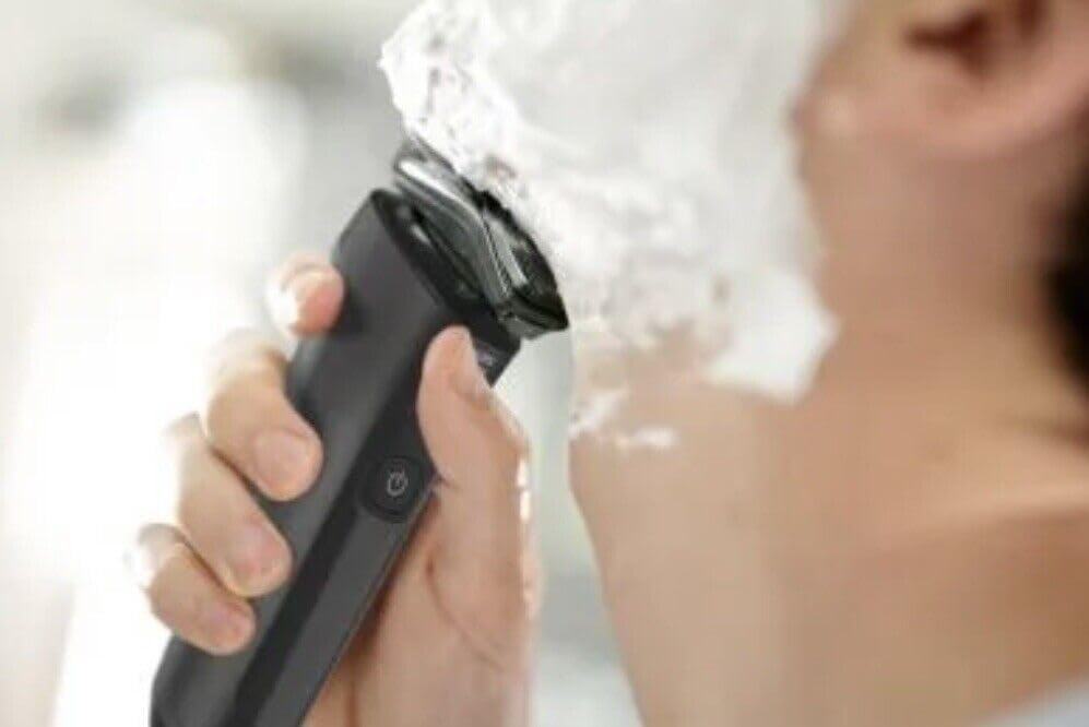 Man using Philips Norelco Shaver 6800 with shaving cream
