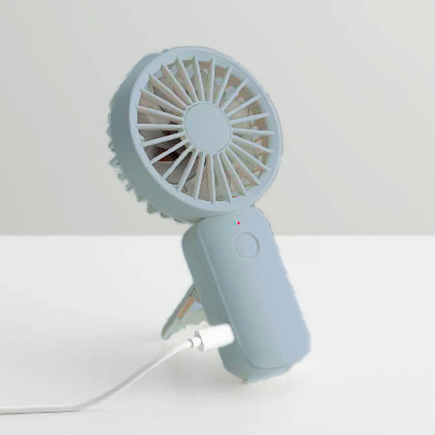 RHYTHM Air Fan connected to a charging cable