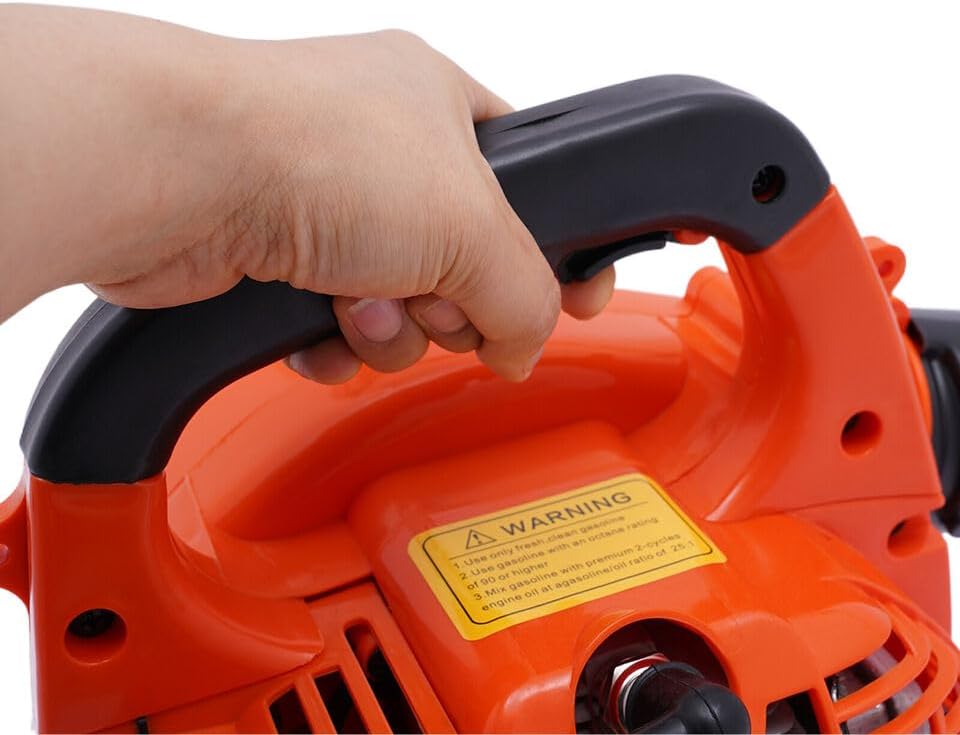 A hand holding the handle of the leaf blower, showing the fuel tank cap and a warning label about fuel mixture.