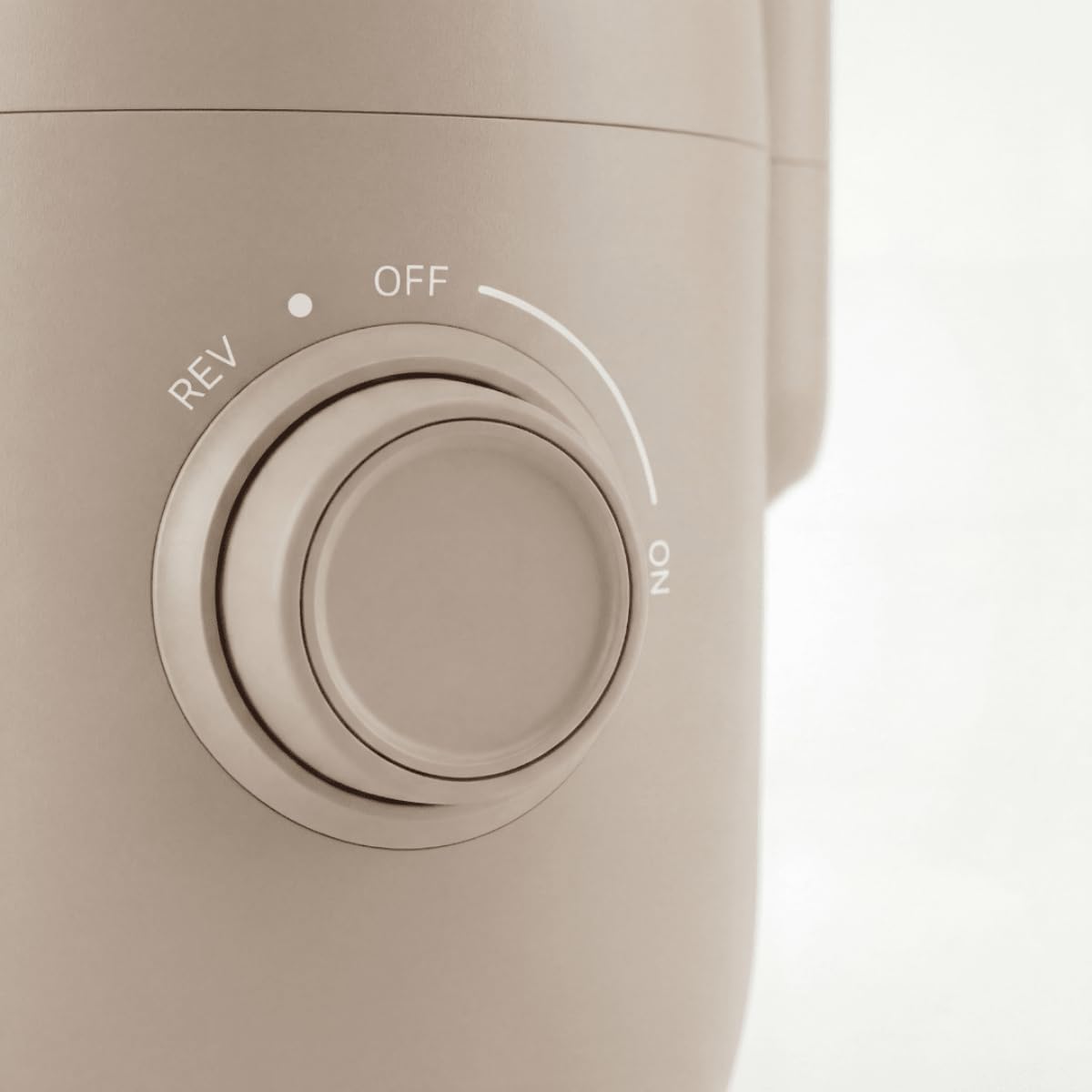 Close-up of the Safecourt Slow Juicer SJ500's control knob with ON, OFF, and REV settings