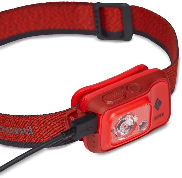 Black Diamond Cosmo 350-R Headlamp with a micro-USB cable plugged into its charging port.